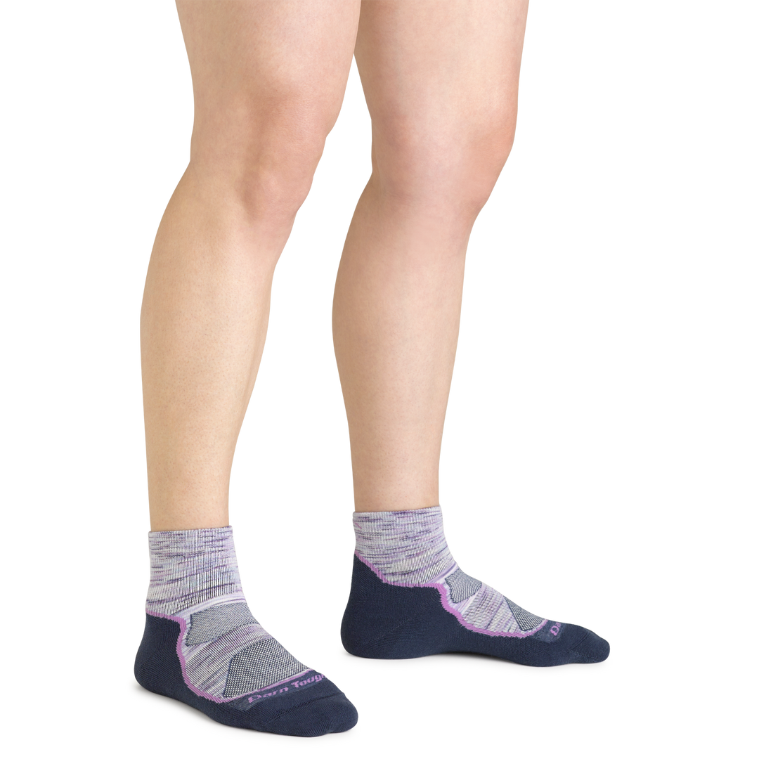 Close up shot of model wearing the women's light hiker quarter hiking sock in cosmic purple with no shoes on