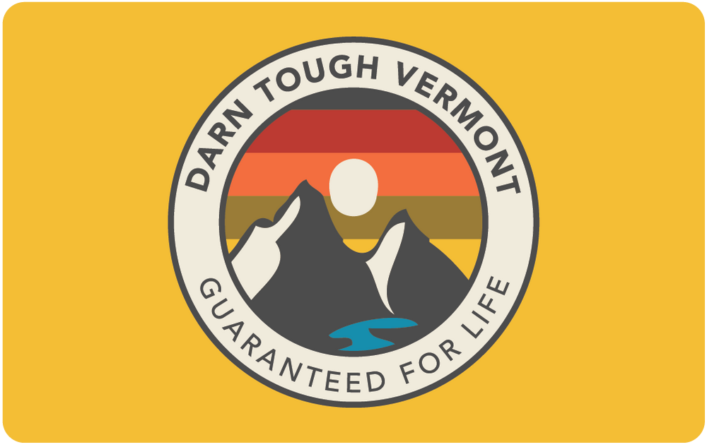 yellow darn tough physical gift card with sunset ridge mountain design and lifetime guarantee