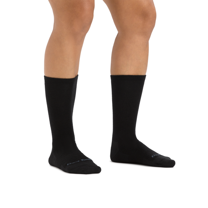 Studio shot of model wearing the women's solid basic crew lifestyle sock in black