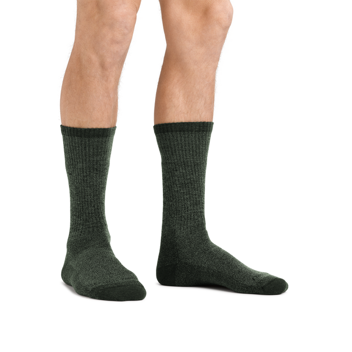 Man standing barefoot wearing  Nomad Boot Midweight Hiking Socks in Moss