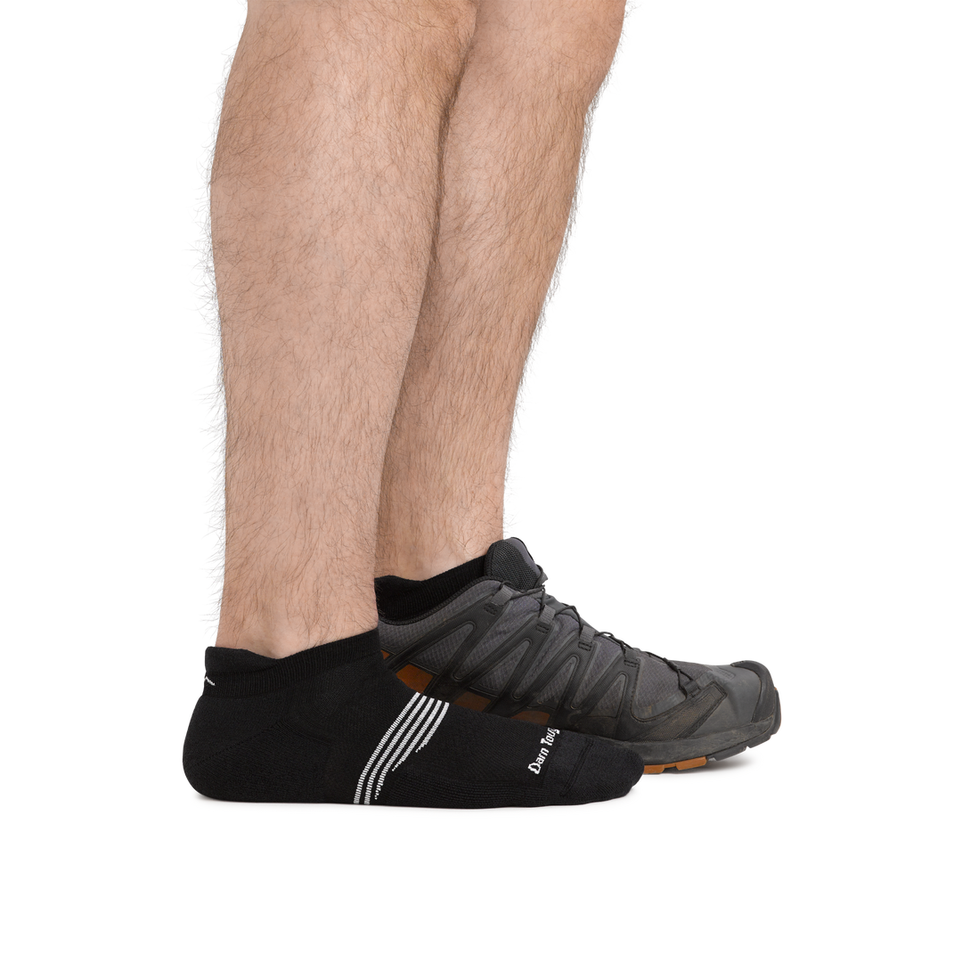 Man standing barefoot wearing Element No Show Tab Lightweight Athletic Socks with Cushion in Black and back foot also wearing an athletic sneaker