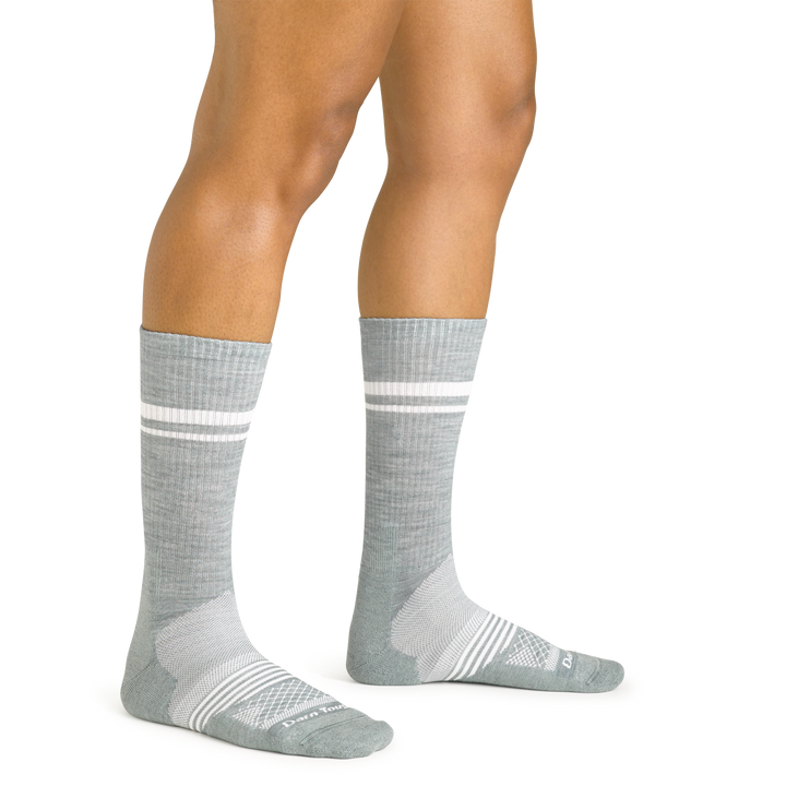 Close up studio shot of model wearing women's element crew lightweight athletic sock in seafoam green