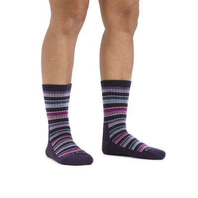 Image of a woman's legs on a white background wearing Women's Decade Stripe Micro Crew Midweight Hiking Socks in Blackberry