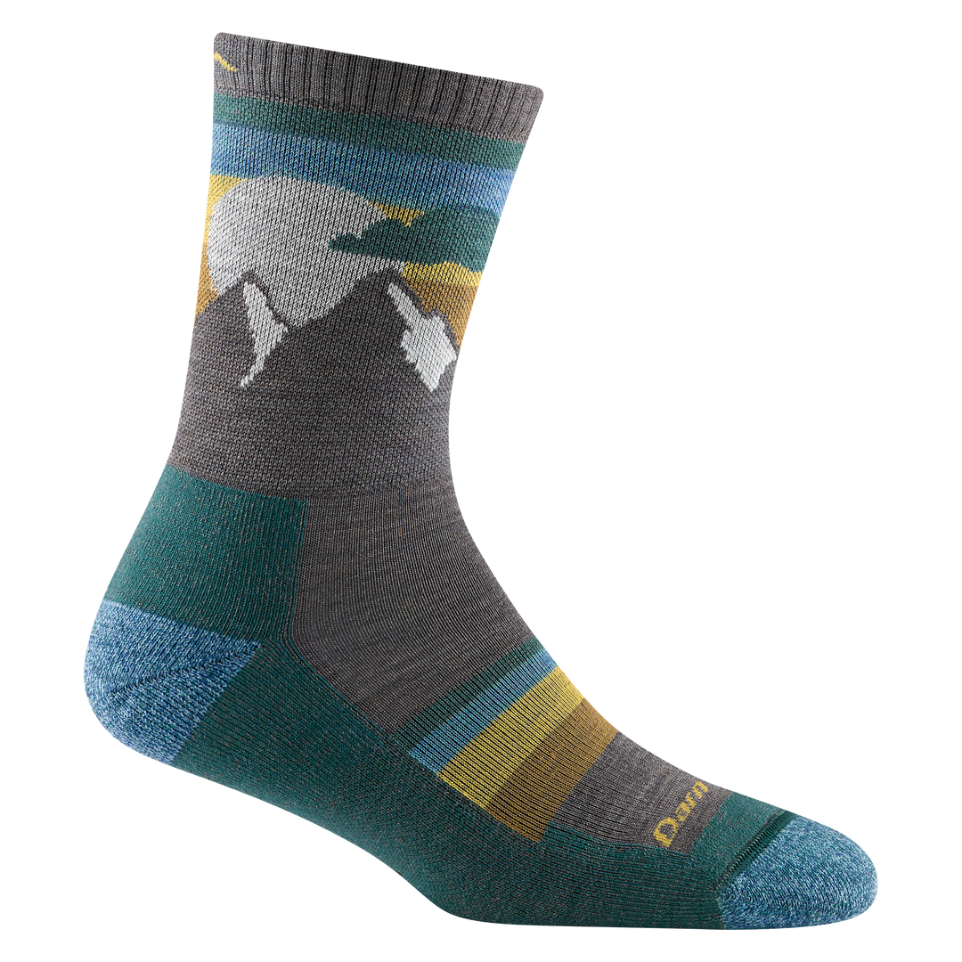Studio shot of women's sunset ledge micro crew in taupe. It has grey and white mountains, and teal and gold striped accents.