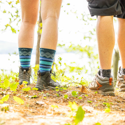 Clock up shot of the back of the models legs wearing the women's ryder boot hiking socks in dark teal