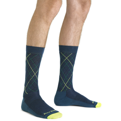 Close up shot of model wearing the men's prep step crew lifestyle socks in dark teal with no shoes on