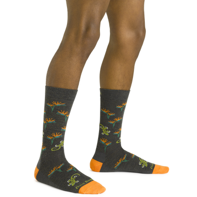 Close up shot of model wearing the men's paradise crew lifestyle socks in charcoal with no shoes on