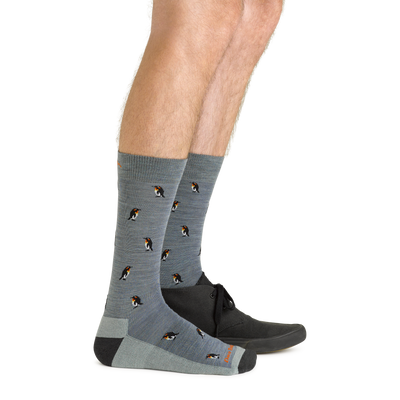 Side studio shot of model wearing men's panda-monium crew lightweight lifestyle sock in seafoam with black shoe on left foot