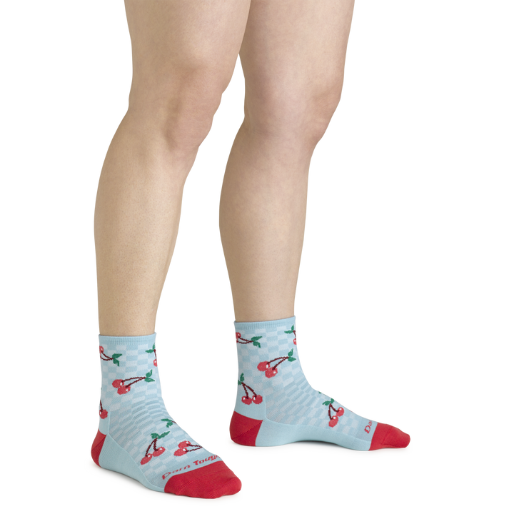 Model wearing the Shorty sock with cherries on them